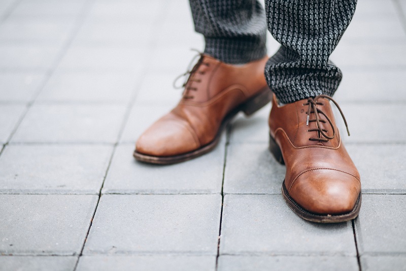 Brogues: The Unique Statement Male brown footwear close up