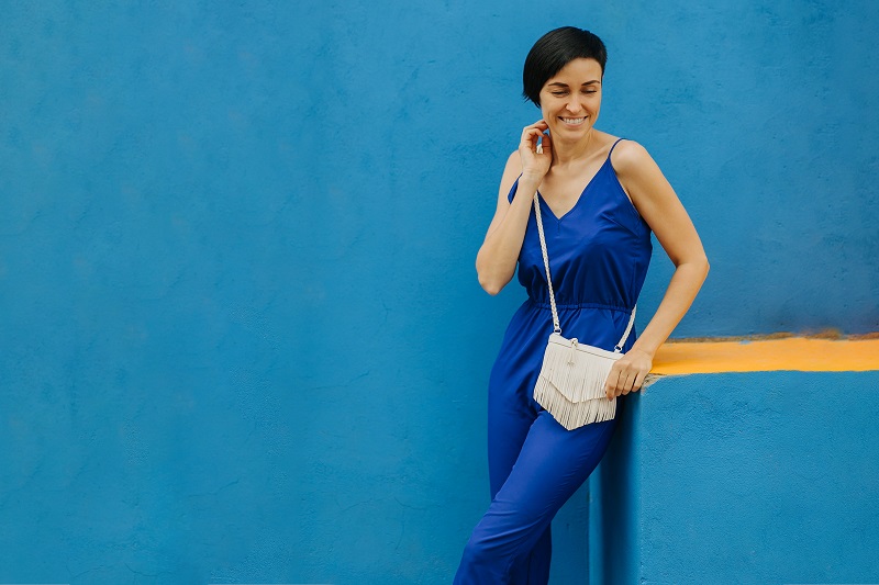 Sling Bags: Modern Convenience Woman in blue clothes on bright blue background in the city.