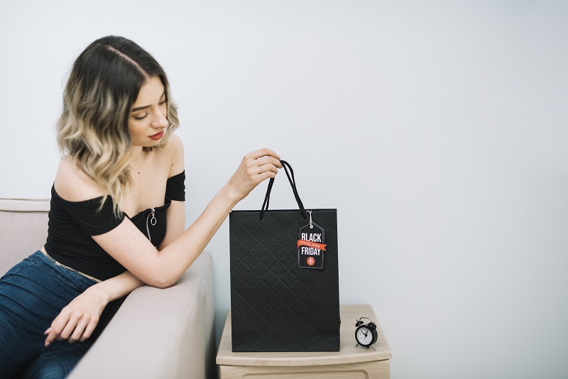 Box Bags: Structured Sophistication A Lady holding black box bag
